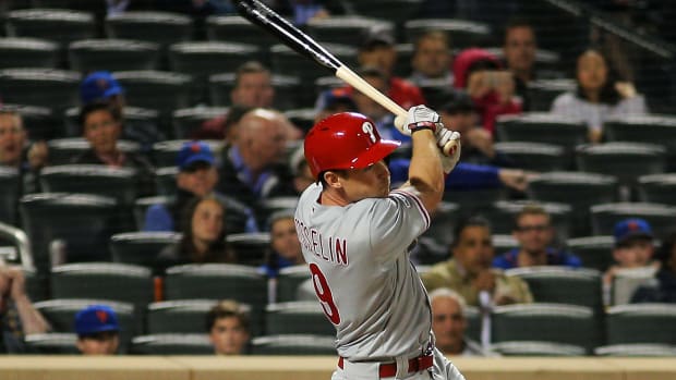 Apr 24, 2019; New York City, NY, USA; Philadelphia Phillies pinch hitter Phil Gosselin (9) hits an RBI single against the New York Mets during the ninth inning at Citi Field. Mandatory Credit: Andy Marlin-USA TODAY Sports